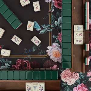 Emerald green American Mahjong tiles arranged on a floral mat
